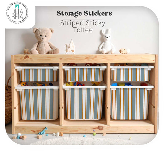 Wooden storage unit featuring plastic bins compatible with IKEA Trofast, decorated with Della Bella Striped Sticky Toffee vinyl decals in slate blue and gold for a neutral playroom.