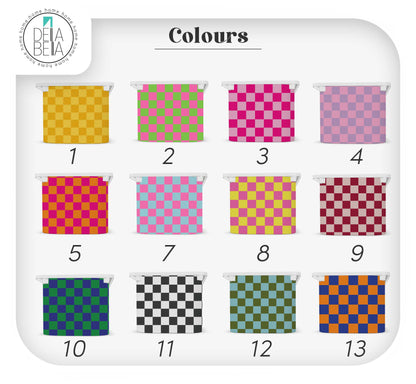 Colour swatch chart showing the 12 available colour options for the checkerboard IKEA Trofast stickers, including pink, yellow, blue, and black & white.