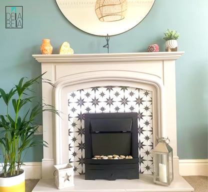 A vinyl wrap with a star pattern applied to a fireplace, surrounded by home decor items such as a plant, candles, and a framed image on the wall.