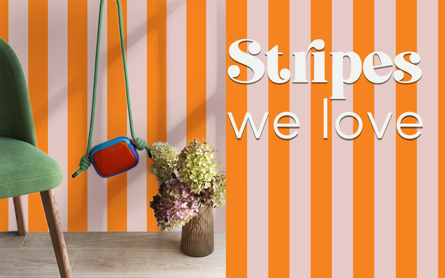 A stylish room with a pink and orange striped wall, showcasing the "Stripes We Love" furniture sticker collection.